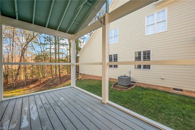 wooden deck featuring central AC unit and a yard