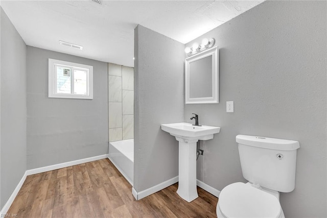 bathroom featuring hardwood / wood-style floors and toilet