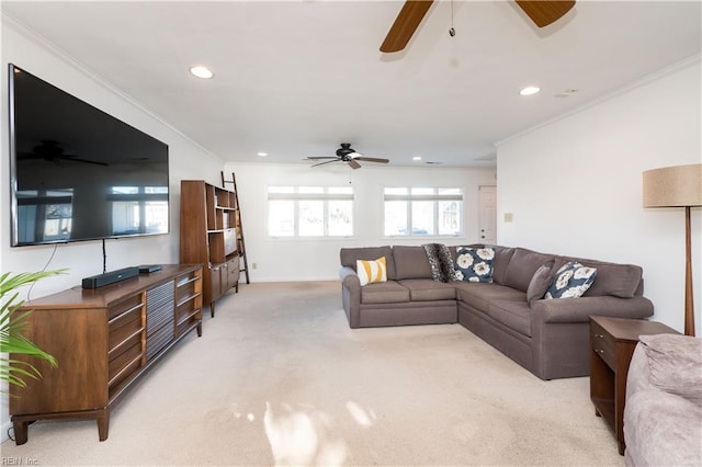 living room with crown molding, light colored carpet, and ceiling fan