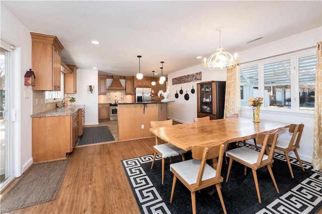 dining room featuring sink and light wood-type flooring