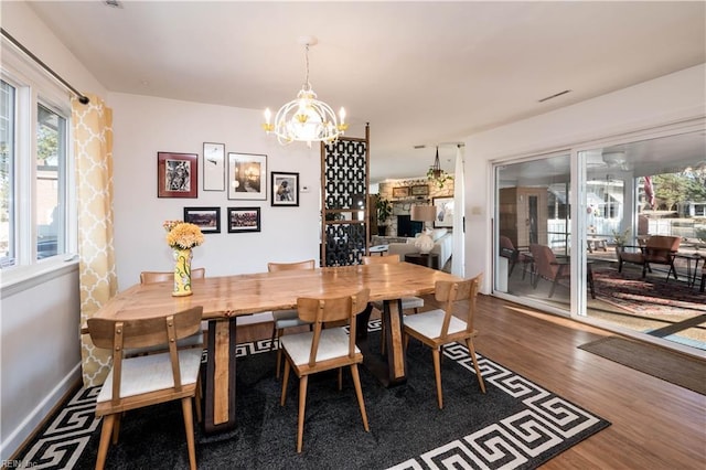 dining area featuring dark hardwood / wood-style floors and a notable chandelier