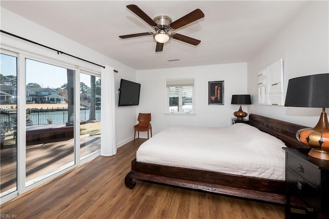 bedroom featuring ceiling fan, access to exterior, and dark hardwood / wood-style flooring