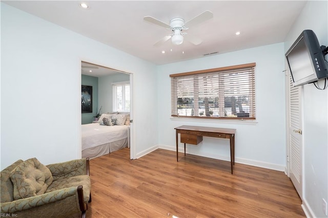 interior space with ceiling fan and wood-type flooring