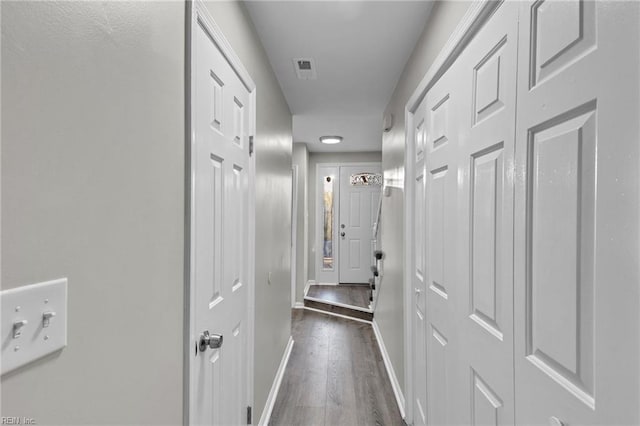 hall with dark hardwood / wood-style flooring