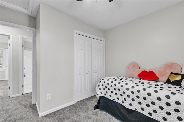 bedroom featuring light colored carpet, a closet, and ceiling fan