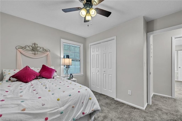 carpeted bedroom with a closet and ceiling fan