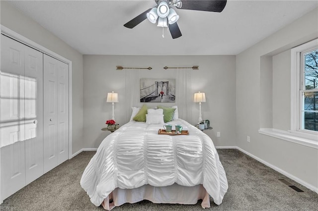 carpeted bedroom with ceiling fan and a closet