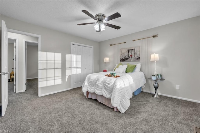 carpeted bedroom featuring ceiling fan, a closet, and a textured ceiling