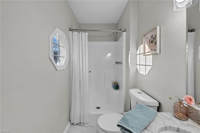 bathroom with toilet and a shower with shower curtain