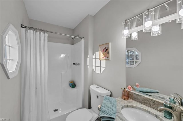 bathroom featuring vanity, a shower with shower curtain, and toilet