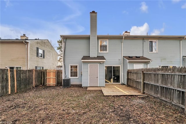 rear view of house with central AC unit