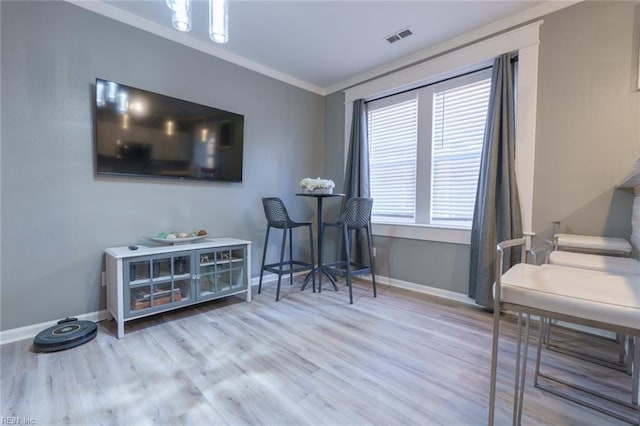 office featuring crown molding and light hardwood / wood-style flooring