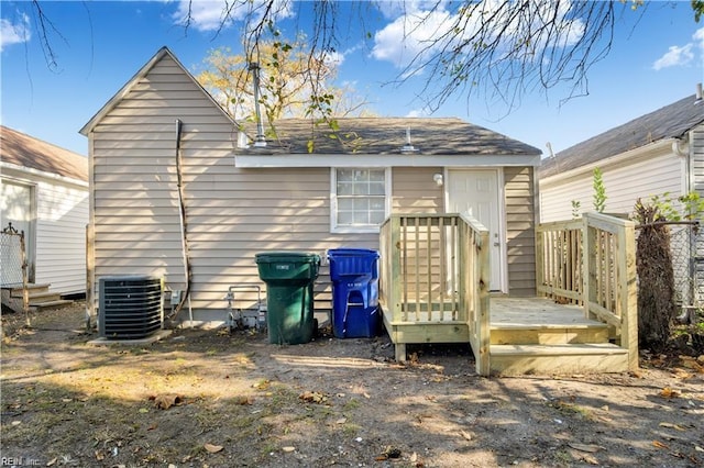 rear view of house featuring cooling unit