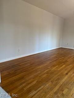 spare room featuring dark wood-type flooring