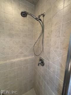 bathroom with tiled shower