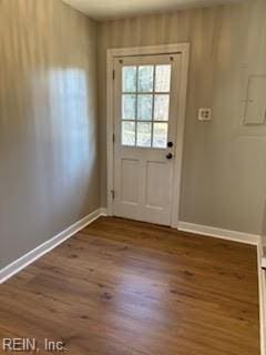 doorway with dark hardwood / wood-style floors and electric panel