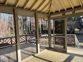 unfurnished sunroom featuring lofted ceiling