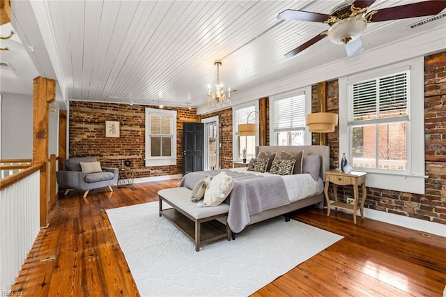 bedroom with an inviting chandelier, wood ceiling, brick wall, and wood-type flooring