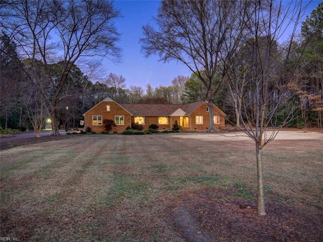 ranch-style house featuring a lawn