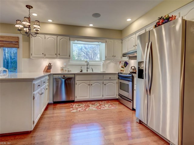 kitchen with stainless steel appliances, white cabinetry, and sink