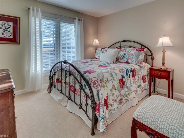 carpeted bedroom featuring multiple windows