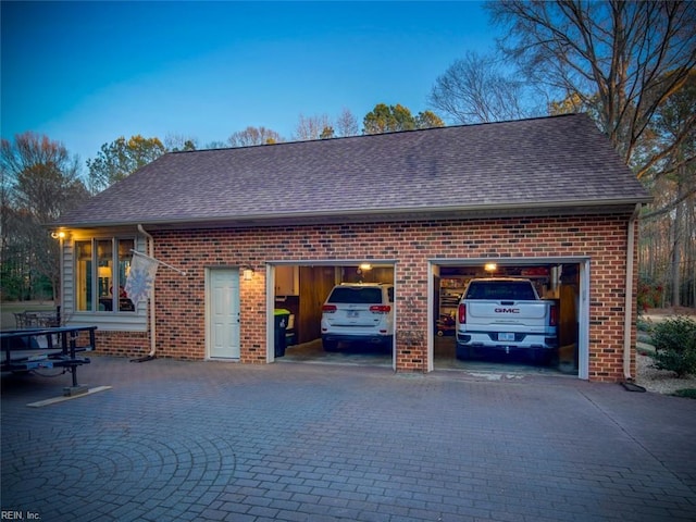 view of garage at dusk