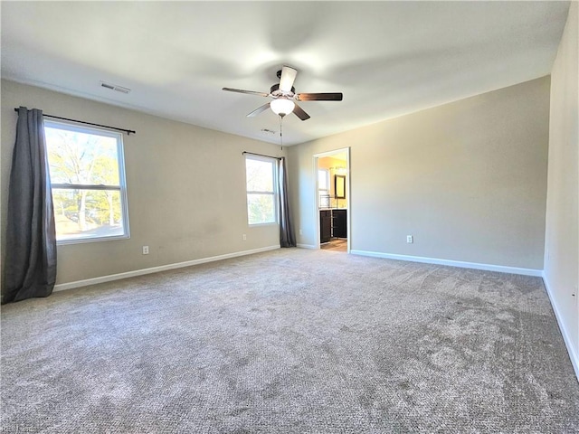 unfurnished room featuring ceiling fan and carpet