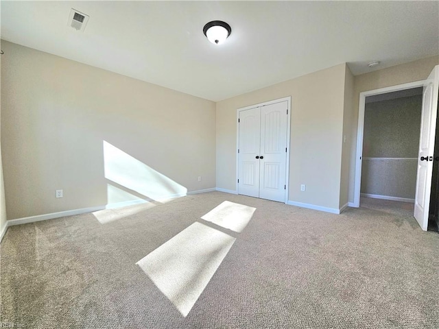 unfurnished bedroom featuring carpet floors and a closet