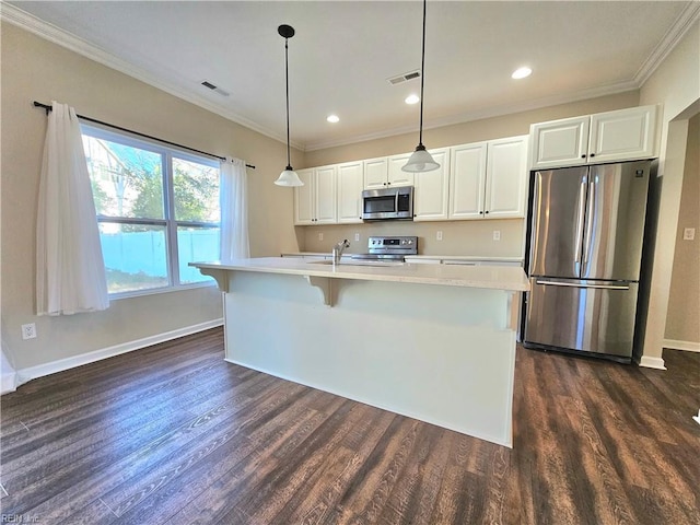 kitchen featuring stainless steel appliances, a kitchen island with sink, hanging light fixtures, and white cabinets