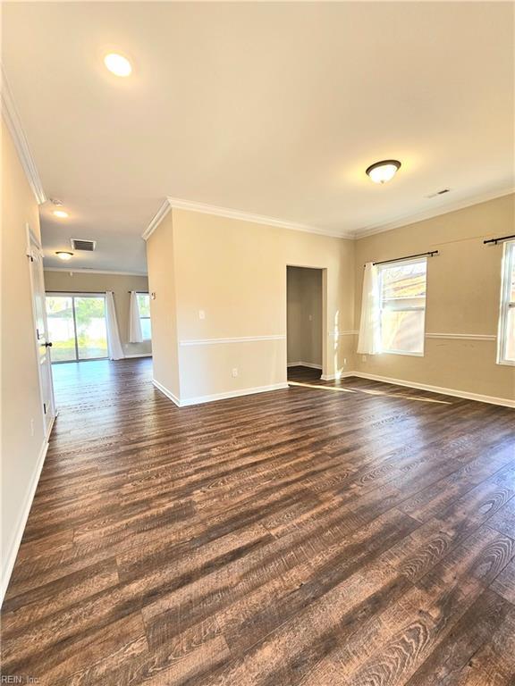 unfurnished room with ornamental molding, dark hardwood / wood-style floors, and a healthy amount of sunlight