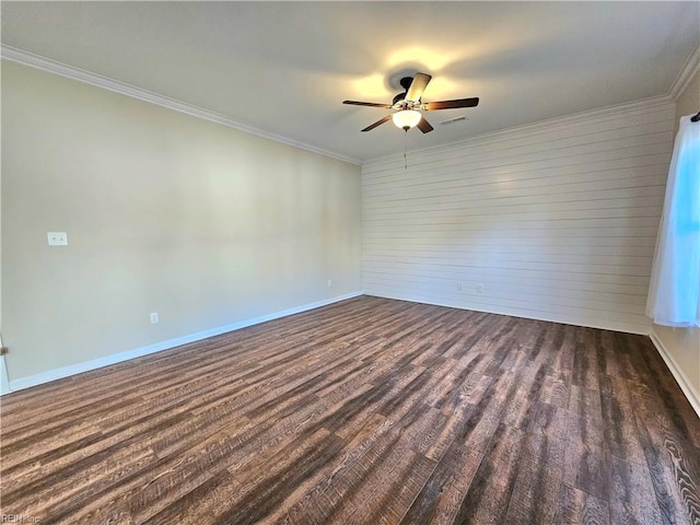 spare room featuring ornamental molding, dark wood-type flooring, and ceiling fan