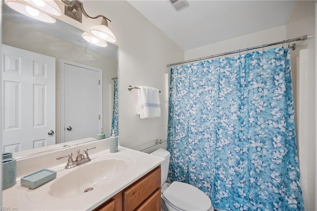 bathroom featuring vanity, curtained shower, and toilet