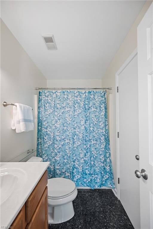 bathroom featuring vanity and toilet