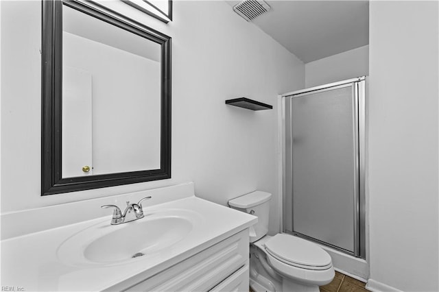 bathroom with vanity, tile patterned floors, toilet, and walk in shower