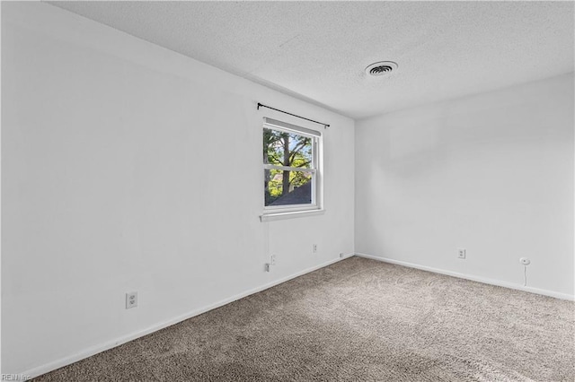 carpeted spare room featuring a textured ceiling