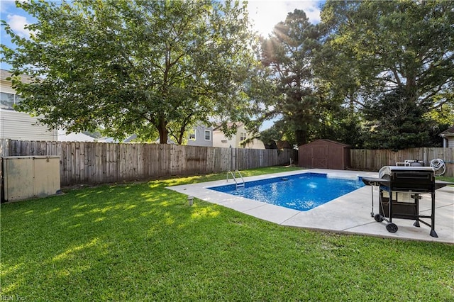 view of pool featuring a storage unit, a patio area, and a lawn