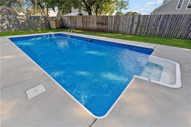 view of swimming pool with a patio