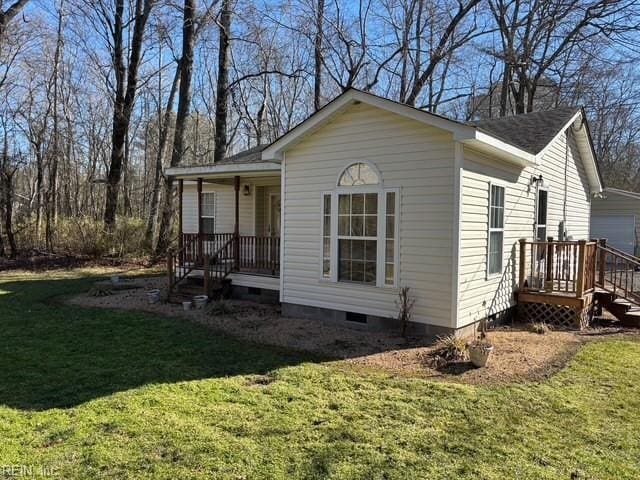 view of side of property with a yard