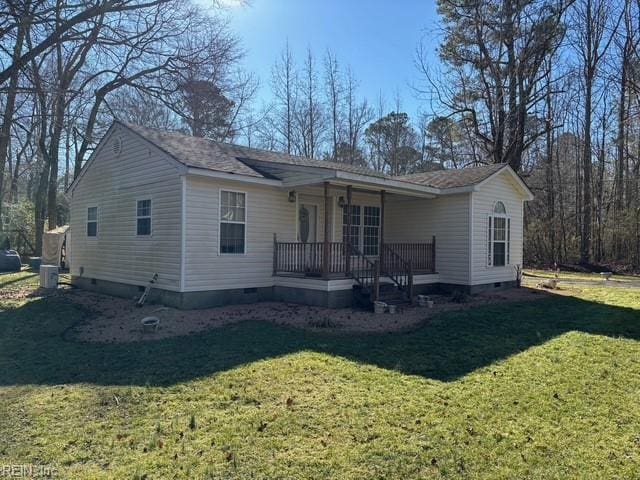 back of property featuring a yard