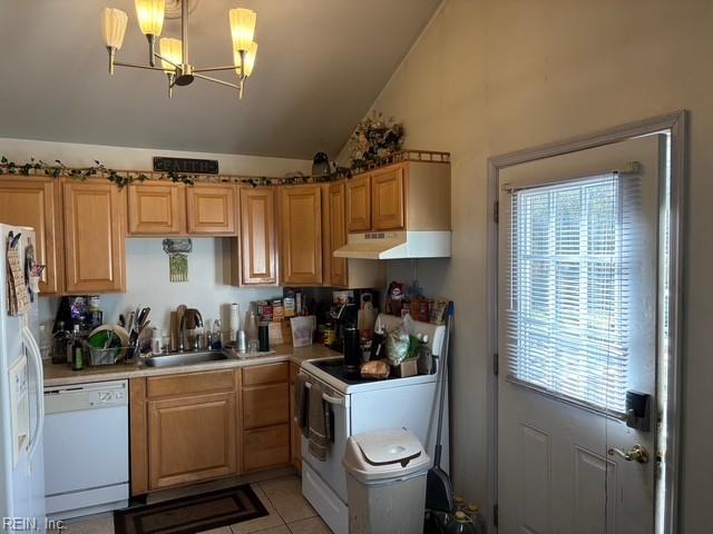 kitchen featuring pendant lighting, lofted ceiling, light tile patterned floors, a notable chandelier, and white appliances