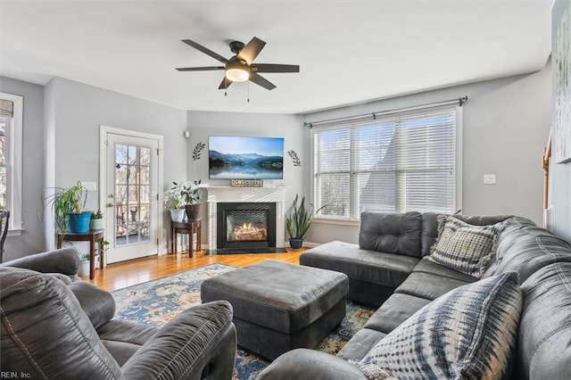 living room featuring hardwood / wood-style floors, a wealth of natural light, and ceiling fan