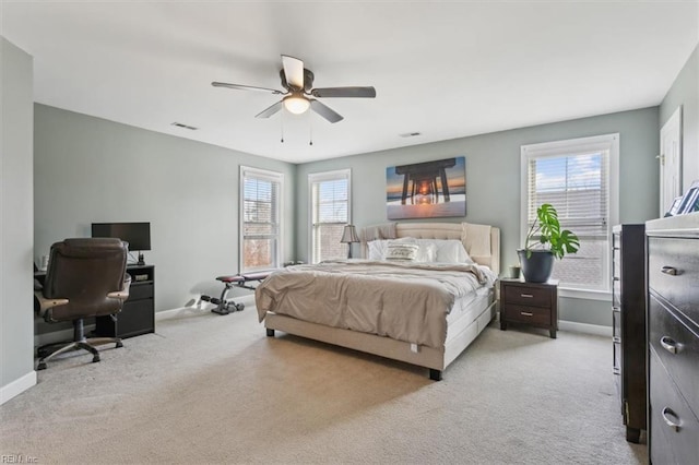 bedroom featuring light colored carpet and ceiling fan