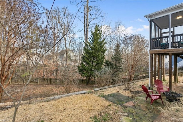 view of yard with a sunroom and an outdoor fire pit