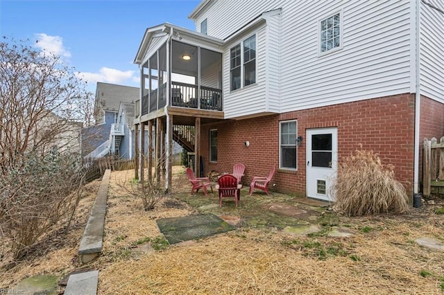 rear view of house featuring a sunroom