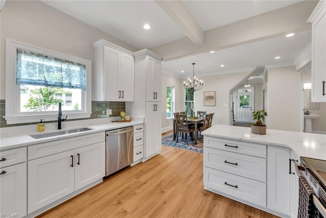 kitchen featuring appliances with stainless steel finishes, beamed ceiling, sink, white cabinets, and light hardwood / wood-style floors