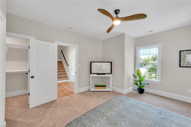 unfurnished bedroom with light colored carpet and ceiling fan