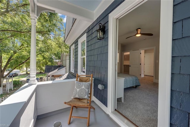 balcony with a porch and ceiling fan