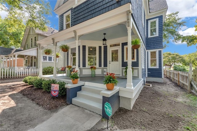 rear view of house featuring a porch