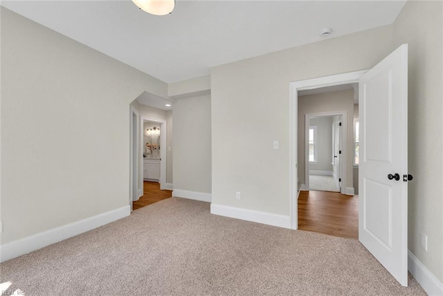 unfurnished bedroom featuring light carpet