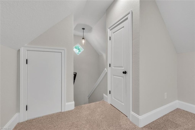 additional living space with lofted ceiling and carpet flooring